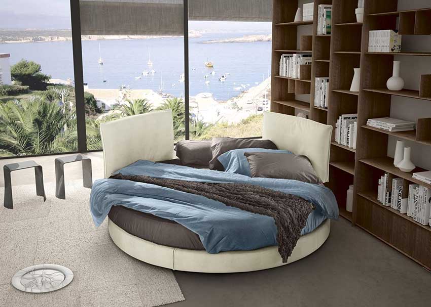 Letto tondo beige ideale per arredare una camera moderna.