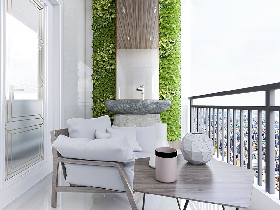 Bellissimo balcone con giardino verticale e salotto da esterno con cuscini bianchi.