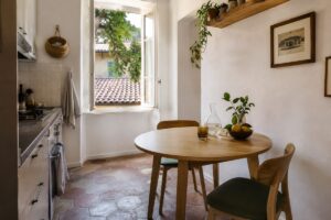 Cucina piccola luminosa con tavolo rotondo in legno chiaro