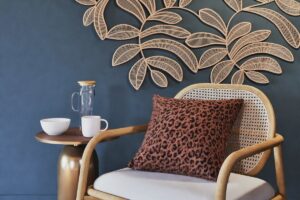 Decorazione Maisons du Monde KAYA in juta su parete blu con poltrona