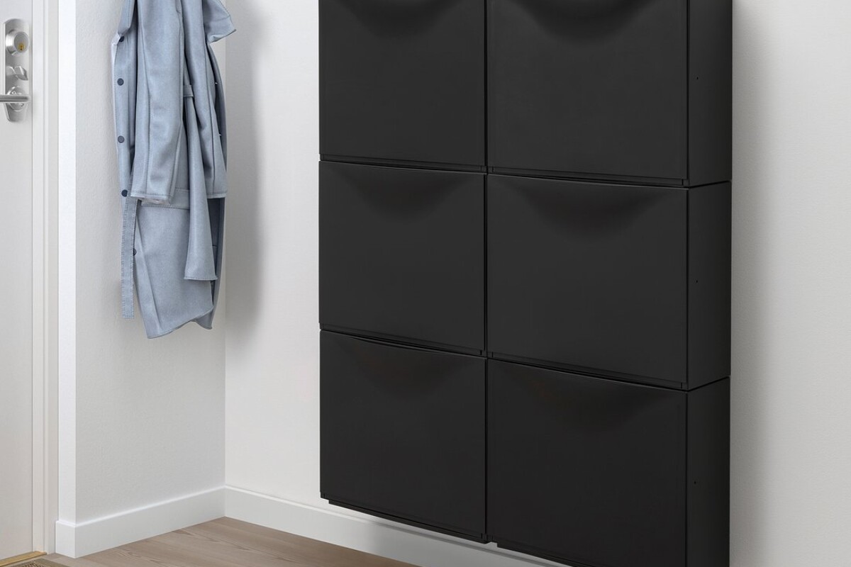 Moduli neri IKEA TRONES montati sulla parete di un ingresso luminoso