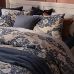 Il copripiumino PJÄXE di IKEA ambientato in una camera con fantasia floreale blu su fondo beige